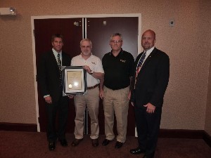 In August, Hart (r) and Brian Osborne (l), chapter vice president for membership, introduce the chapter's newest corporate members: Dave London (2nd from l) and Joe Smith of Tridec Technologies.